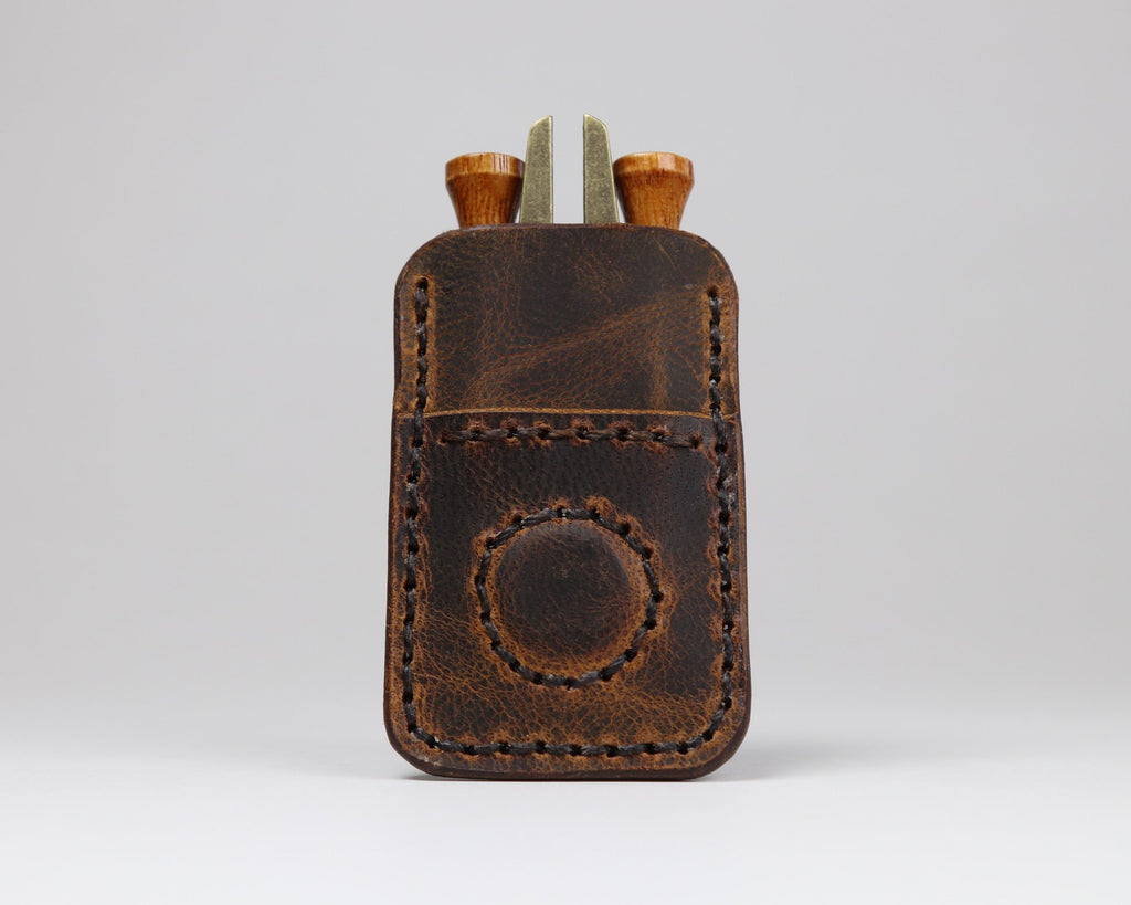 Rich heritage brown leather golf pocket caddy with magnetic ball marker holder and sleeve to hold golf tees and divot tool.